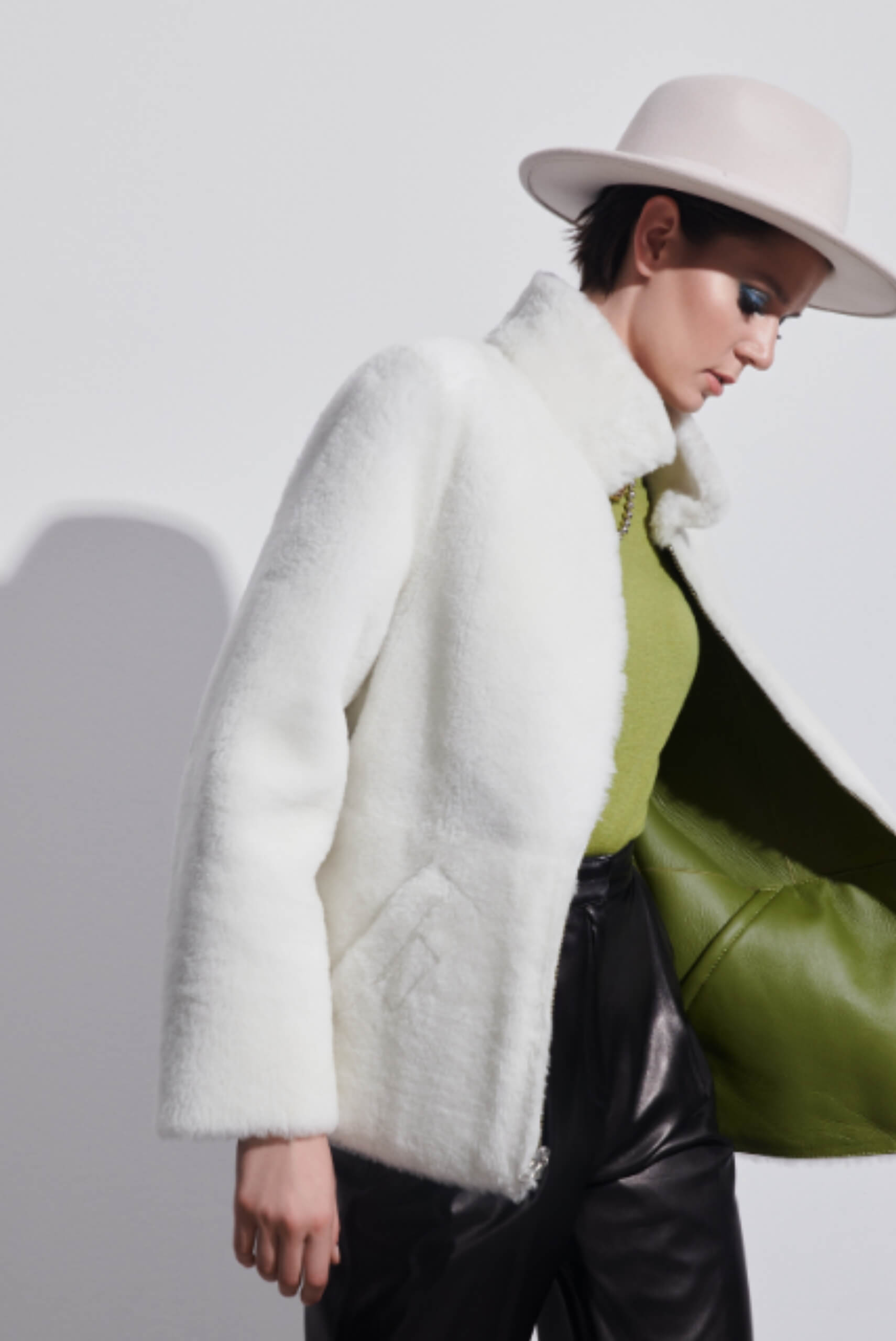 a woman in a white hat and white fur coat