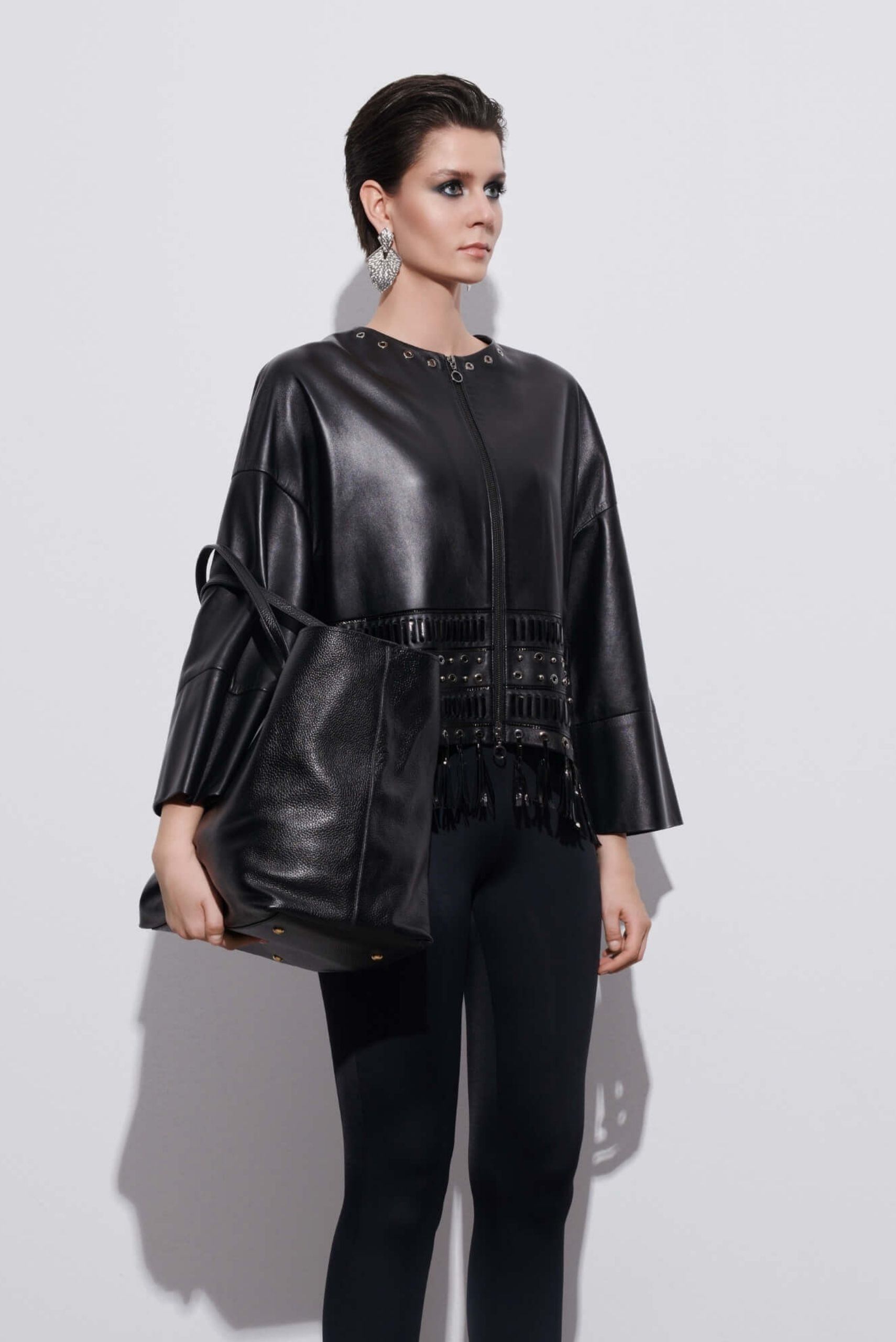 Woman wearing a black leather jacket styled with a skirt — classic and timeless leather fashion